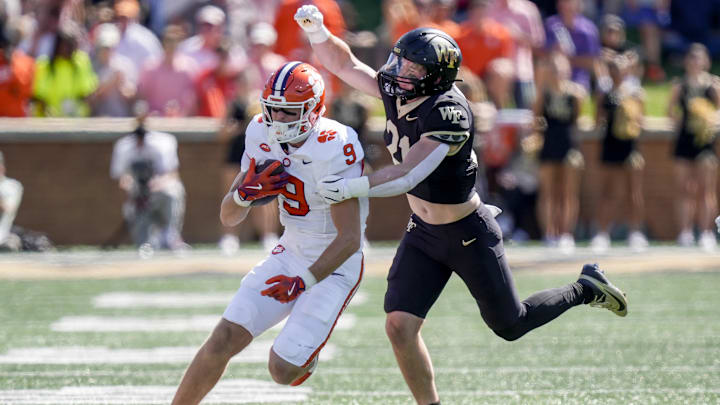 Oct 12, 2024; Winston-Salem, North Carolina, USA; Wake Forest Demon Deacons linebacker Branson Combs (21) tries to stop Clemson Tigers tight end Jake Briningstool (9) during the first half at Allegacy Federal Credit Union Stadium. 