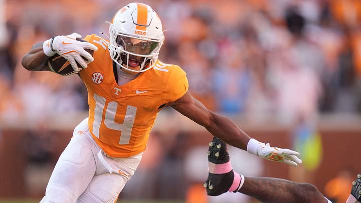 Tennessee wide receiver Braylon Staley (14) breaks a tackled from Arkansas defensive back Miguel Mitchell (16) in an NCAA college football game on Oct. 11, 2025, in Knoxville, Tennessee.