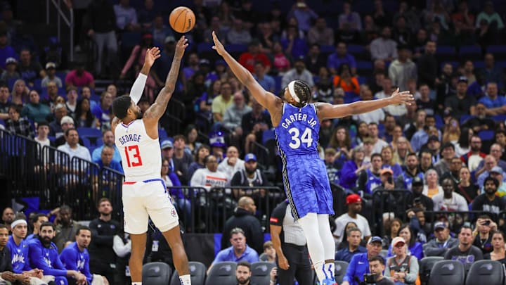 Mar 29, 2024; Orlando, Florida, USA; LA Clippers forward Paul George (13) shoots the ball over Orlando Magic center Wendell Carter Jr. (34) during the first quarter at KIA Center. Mandatory Credit: Mike Watters-USA TODAY Sports