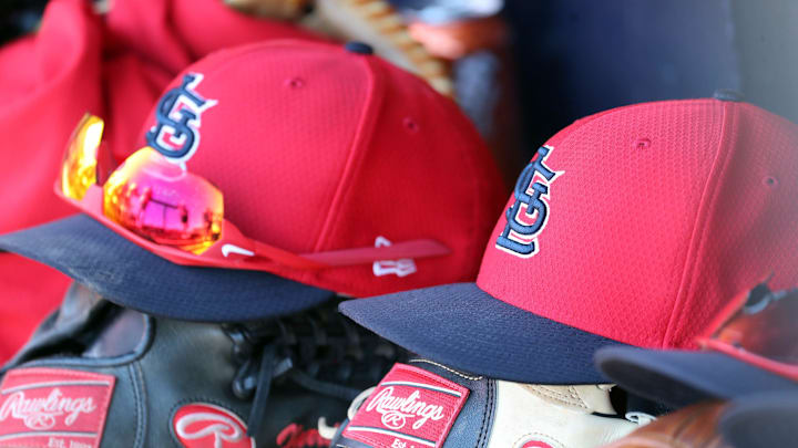 Mar 6, 2019; Tampa, FL, USA; St. Louis Cardinals hat and gloves lay in the dugout at George M. Steinbrenner Field. Mandatory Credit: Kim Klement-Imagn Images