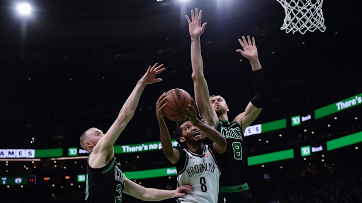 Mar 18, 2025; Boston, Massachusetts, USA: Brooklyn Nets forward Ziaire Williams (8) drives to the basket while Boston Celtics center Kristaps Porzingis (8) defends during the first half at TD Garden. Mandatory Credit: Bob DeChiara-Imagn Images