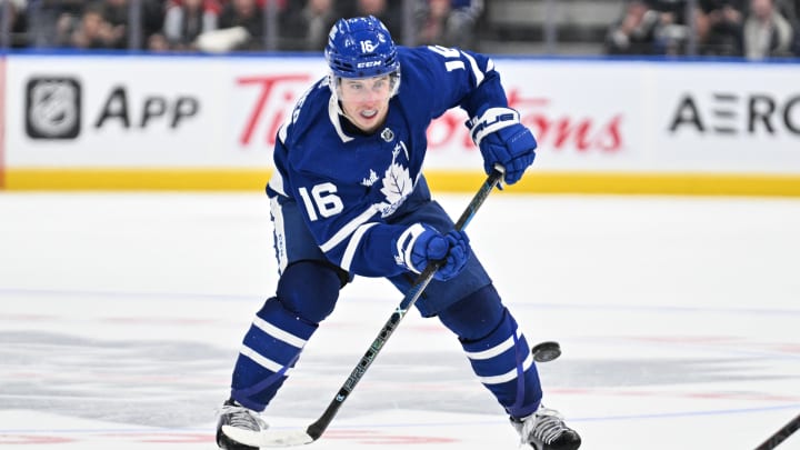 Apr 11, 2024; Toronto, Ontario, CAN; Toronto Maple Leafs forward Mitchell Marner (16) plays the puck against the New Jersey Devils in the third period at Scotiabank Arena. Mandatory Credit: Dan Hamilton-USA TODAY Sports