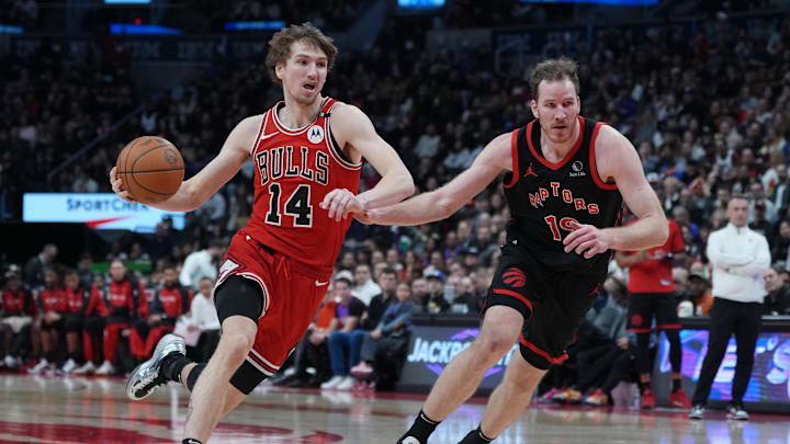 Jan 31, 2025; Toronto, Ontario, CAN: Chicago Bulls forward Matas Buzelis (14) controls the ball as Toronto Raptors center Jakob Poeltl (19) tries to defend during the third quarter at Scotiabank Arena. Mandatory Credit: Nick Turchiaro-Imagn Images