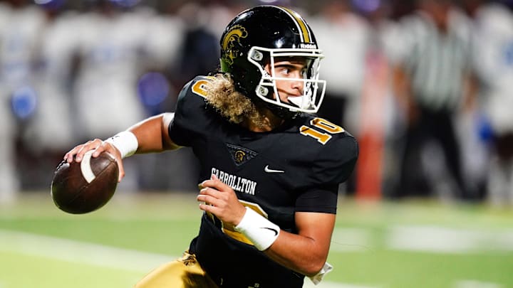 Oct 20, 2023; Carrollton, GA, USA; Carrollton Trojans quarterback Julian Lewis (10) scrambles out of the pocket against the Westlake Lions during the first half at Grisham Stadium. The 15-year-old Carrollton High student has already committed to playing for the University of Southern California Trojans and has been considered one of the top high school quarterback prospects.