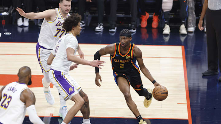Apr 6, 2025; Oklahoma City, Oklahoma, USA; Oklahoma City Thunder guard Shai Gilgeous-Alexander (2) drives around Los Angeles Lakers center Jaxson Hayes (11) during the first quarter at Paycom Center. Mandatory Credit: Alonzo Adams-Imagn Images