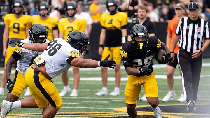 Iowa running back Kamari Moulton (28) carries the football away from the reach of Iowa defensive lineman Bryce Hawthorne (96) Aug. 15, 2026 during the Kids Day at Kinnick open practice at Kinnick Stadium in Iowa City, Iowa.