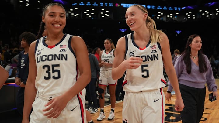 Dec 7, 2024; Brooklyn, New York, USA; Connecticut Huskies guard Azzi Fudd (35) and Connecticut Huskies guard Paige Bueckers (5) celebrate after the game against the Louisville Cardinals at Barclays Center. Mandatory Credit: Lucas Boland-Imagn Images