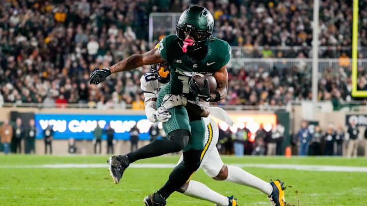 Oct 25, 2025; East Lansing, Michigan, USA; Michigan State Spartans wide receiver Chrishon McCray (13) is tackled after the catch by Michigan Wolverines defensive back Jyaire Hill (20) during the first half at Spartan Stadium. Mandatory Credit: Brendan Mullin-Imagn Images