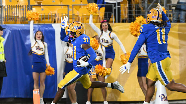 Oct 24, 2024; Pittsburgh, Pennsylvania, USA; Pittsburgh Panthers linebacker Rasheem Biles (31) returns an interception for a touchdown against the Syracuse Orange during the first quarter  at Acrisure Stadium. Mandatory Credit: Barry Reeger-Imagn Images