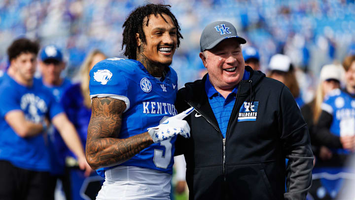 Nov 15, 2025; Lexington, Kentucky, USA; Kentucky Wildcats head coach Mark Stoops poses for a photo with running back Seth McGowan (3) at the senior day celebration before the game against the Tennessee Tech Golden Eagles at Kroger Field. Mandatory Credit: Jordan Prather-Imagn Images