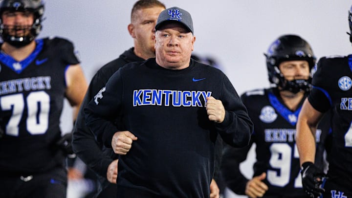 Oct 25, 2025; Lexington, Kentucky, USA; Kentucky Wildcats head coach Mark Stoops runs onto the field before the game against the Tennessee Volunteers at Kroger Field. Mandatory Credit: Jordan Prather-Imagn Images