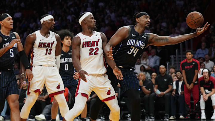 Orlando Magic center Wendell Carter Jr. (34) reaches for a rebound as Miami Heat forward Jimmy Butler (22) looks on during the first half at Kaseya Center.