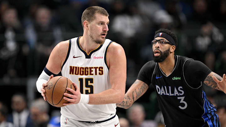 Dec 23, 2025; Dallas, Texas, USA; Denver Nuggets center Nikola Jokic (15) looks to move the ball past Dallas Mavericks forward Anthony Davis (3) during the game between the Mavericks and the Nuggets at the American Airlines Center.