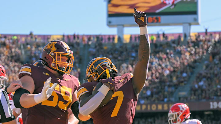 Sep 27, 2025; Minneapolis, Minnesota, USA; Minnesota Golden Gophers running back Fame Ijeboi (7) celebrates his two-yard touchdown run against Rutgers Scarlet Knights with offensive lineman Tony Nelson (59) during the second quarter at Huntington Bank Stadium. Mandatory Credit: Nick Wosika-Imagn Images Sep 27, 2025; Minneapolis, Minnesota, USA; Minnesota Golden Gophers running back Fame Ijeboi (7) celebrates his two-yard touchdown run against Rutgers Scarlet Knights with offensive lineman Tony Nelson (59) during the second quarter at Huntington Bank Stadium. Mandatory Credit: Nick Wosika-Imagn Images