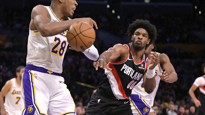 Dec 8, 2024; Los Angeles, California, USA;  Los Angeles Lakers forward Rui Hachimura (28) is defended by Portland Trail Blazers guard Scoot Henderson (00) as he goes for a rebound in the first half at Crypto.com Arena. Mandatory Credit: Jayne Kamin-Oncea-Imagn Images