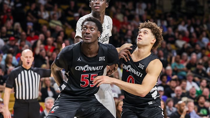 Feb 5, 2025; Orlando, Florida, USA; Cincinnati Bearcats forward Aziz Bandaogo (55), guard Dan Skillings Jr. (0) and UCF Knights center Moustapha Thiam (52) during the second half at Addition Financial Arena. Mandatory Credit: Mike Watters-Imagn Images