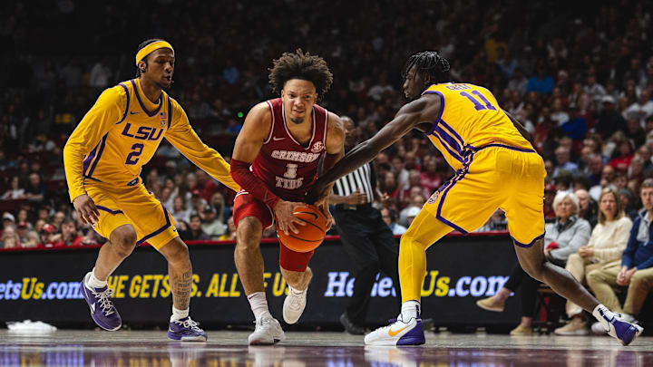 Jan 25, 2025; Tuscaloosa, Alabama, USA; Alabama Crimson Tide guard Mark Sears (1) drives the ball against LSU Tigers guard Mike Williams III (2) and forward Corey Chest (11) during the first half at Coleman Coliseum. Mandatory Credit: Will McLelland-Imagn Images