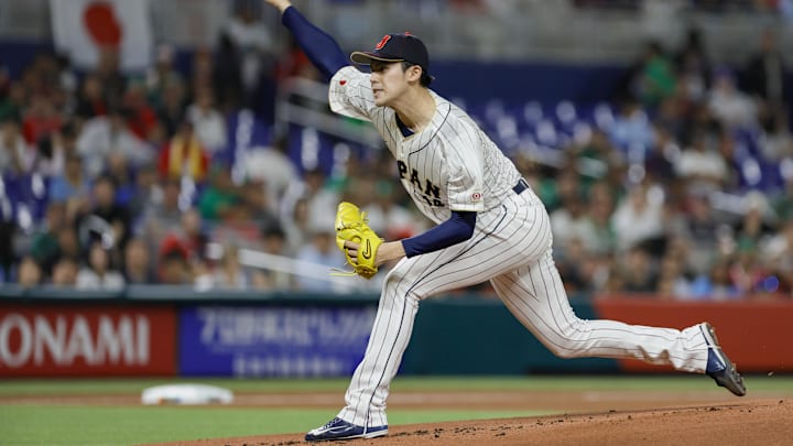 Mar 20, 2023; Miami, Florida, USA; Japan starting pitcher Roki Sasaki (14) delivers a pitch during the first inning against Mexico at LoanDepot Park. Mandatory Credit: Sam Navarro-Imagn Images