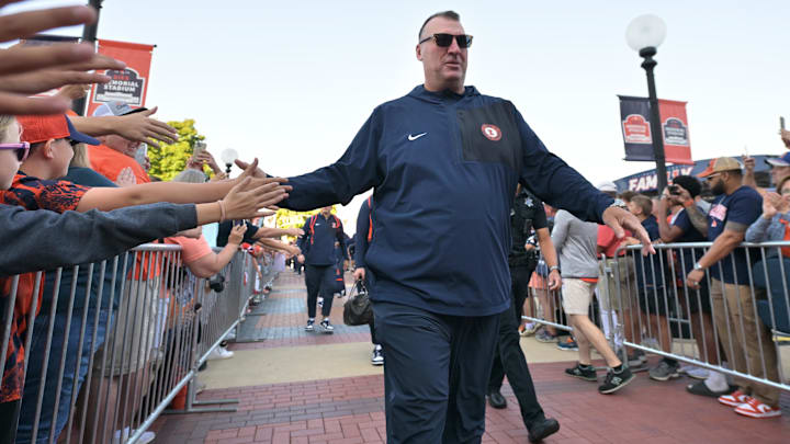 Sep 27, 2025; Champaign, Illinois, USA;  Illinois Fighting Illini head coach Bret Bielema leads his team down the Illini Walk before an NCAA football game with the Southern California Trojans at Memorial Stadium. Mandatory Credit: Ron Johnson-Imagn Images