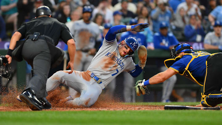 Jul 3, 2025; Seattle, Washington, USA; Kansas City Royals shortstop Bobby Witt Jr. (7) scores a run past Seattle Mariners catcher Cal Raleigh (29) during the seventh inning at T-Mobile Park. Mandatory Credit: Steven Bisig-Imagn Images