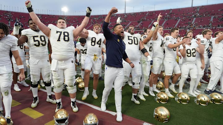 Nov 30, 2024; Los Angeles, California, USA; Notre Dame Fighting Irish head coach Marcus Freeman celebrates with players at the end of the game against the Southern California Trojans at United Airlines Field at Los Angeles Memorial Coliseum. Mandatory Credit: Kirby Lee-Imagn Images