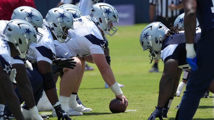 A general view of helmets at the line of scrimmage as Dallas Cowboys center Cooper Beebe snaps the ball. 