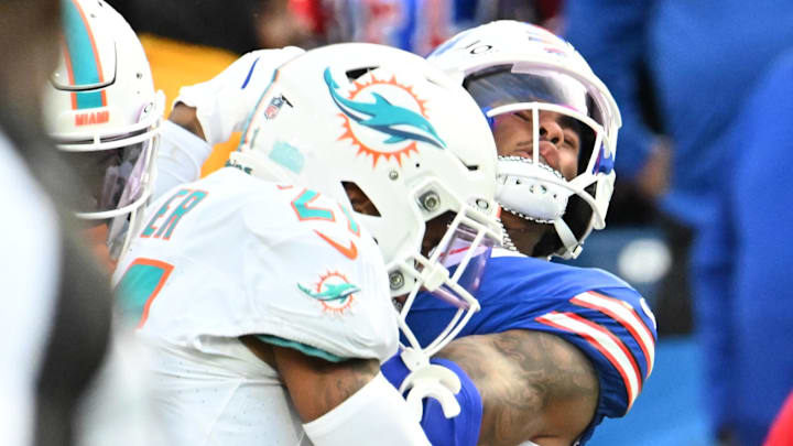 Buffalo Bills wide receiver Keon Coleman (0) is hit in the helmet by Miami Dolphins safety Jordan Poyer (21) resulting in a personal foul penalty on Poyer in the fourth quarter at Highmark Stadium. 