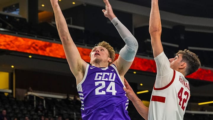 Grand Canyon forward Duke Brennan (24) jumps up for a basket while guarded by Stanford forward Maxime Raynaud (42) during the first half of their game in the Acrisure Series in Palm Desert, Calif., Tuesday, Nov. 26, 2024.