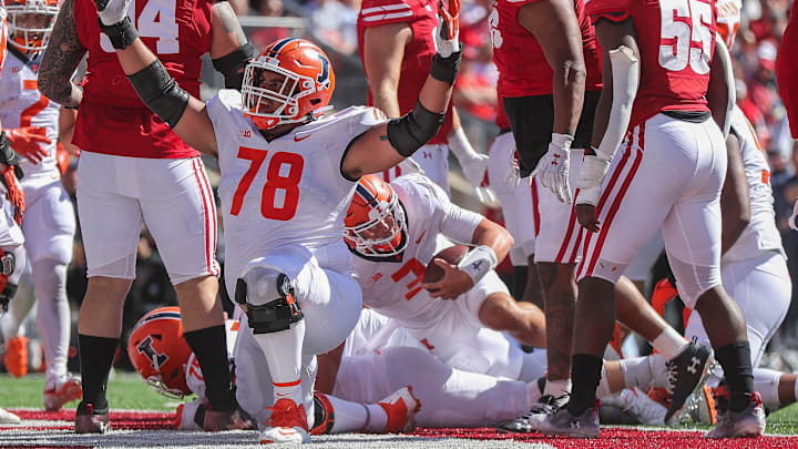 Illinois offensive lineman Isaiah Adams signals for a touchdown after quarterback Tommy DeVito (3) scores a touchdown on Saturday, October 1, 2022, at Camp Randall Stadium in Madison, Wis.