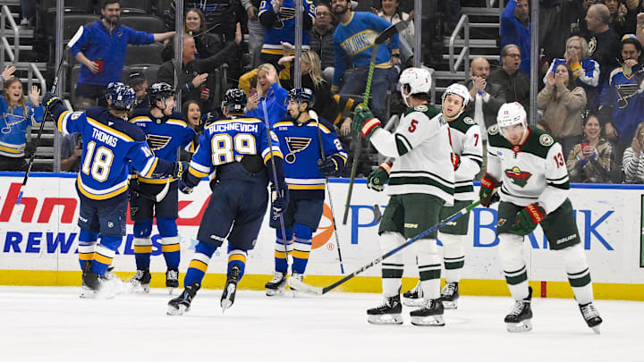 Nov 19, 2024; St. Louis, Missouri, USA;  St. Louis Blues left wing Jake Neighbours (63) is congratulated by teammates after scoring against the Minnesota Wild during the third period at Enterprise Center. Mandatory Credit: Jeff Curry-Imagn Images