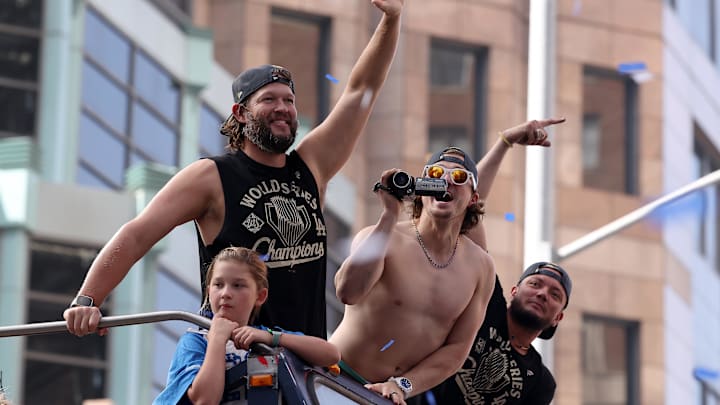 Nov 3, 2025; Los Angeles, CA, USA;  Los Angeles Dodgers pitcher Clayton Kershaw (left) and first baseman Enrique Hernandez (middle) and second baseman Miguel Rojas (right) acknowledge the crowd during the World Series championship parade at downtown Los Angeles. Mandatory Credit: Kiyoshi Mio-Imagn Images