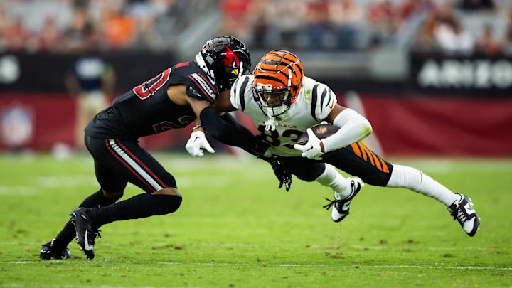 Oct 8, 2023; Glendale, Arizona, USA; Cincinnati Bengals wide receiver Tyler Boyd (83) dives for yardage as he is tackled by Arizona Cardinals cornerback Marco Wilson (20) in the second half at State Farm Stadium. Mandatory Credit: Mark J. Rebilas-Imagn Images Oct 8, 2023; Glendale, Arizona, USA; Cincinnati Bengals wide receiver Tyler Boyd (83) dives for yardage as he is tackled by Arizona Cardinals cornerback Marco Wilson (20) in the second half at State Farm Stadium. Mandatory Credit: Mark J. Rebilas-Imagn Images