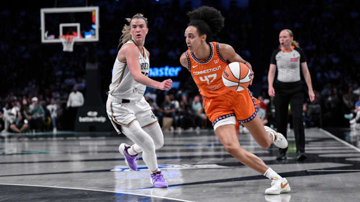 Aug 25, 2025; Brooklyn, New York, USA; Connecticut Sun guard Leila Lacan (47) drives past New York Liberty guard Sabrina Ionescu (20) during the second half at Barclays Center.