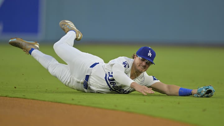 Los Angeles Dodgers center fielder Esteury Ruiz (9) reaches for the ball during the second inning against the New York Mets at Dodger Stadium. 