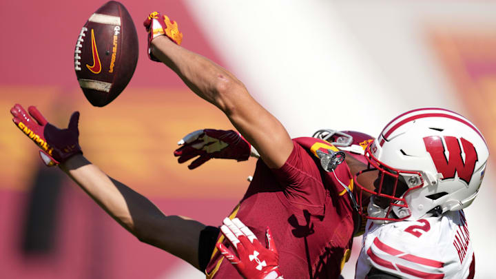 Sep 28, 2024; Los Angeles, California, USA; Southern California Trojans wide receiver Duce Robinson (2) attempts to catch the ball against Wisconsin Badgers cornerback Ricardo Hallman (2) in the second half at United Airlines Field at Los Angeles Memorial Coliseum. Mandatory Credit: Kirby Lee-Imagn Images