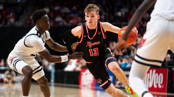 ADM's Hudson Lorensen (13) drives past his defender Ballard’s Jude Gibson (23) on March 13, 2026, at Casey’s Center in Des Moines.