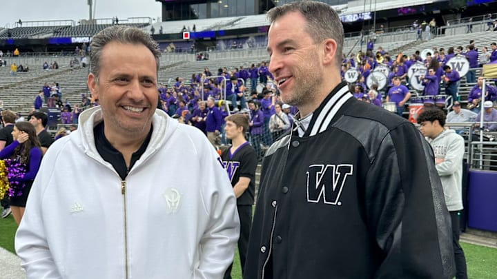 Jedd Fisch, shown with new basketball coach Danny Sprinkle, broke out an all-white sweat suit for the spring game. Jedd Fisch, shown with new basketball coach Danny Sprinkle, broke out an all-white sweat suit for the spring game.