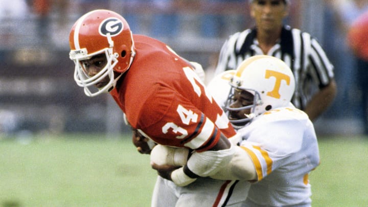 Sep 5, 1981; Athens, GA, USA; FILE PHOTO; Georgia Bulldogs running back Herschel Walker (34) carries the ball against the Tennessee Volunteers at Sanford Stadium. Mandatory Credit: Manny Rubio-Imagn Images. Sep 5, 1981; Athens, GA, USA; FILE PHOTO; Georgia Bulldogs running back Herschel Walker (34) carries the ball against the Tennessee Volunteers at Sanford Stadium. Mandatory Credit: Manny Rubio-Imagn Images.