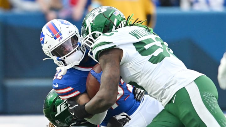 Dec 29, 2024; Orchard Park, New York, USA; Buffalo Bills running back Ray Davis (22) is tackled by New York Jets linebacker Quincy Williams (56) and linebacker Jamien Sherwood (44) in the fourth quarter at Highmark Stadium. Mandatory Credit: Mark Konezny-Imagn Images