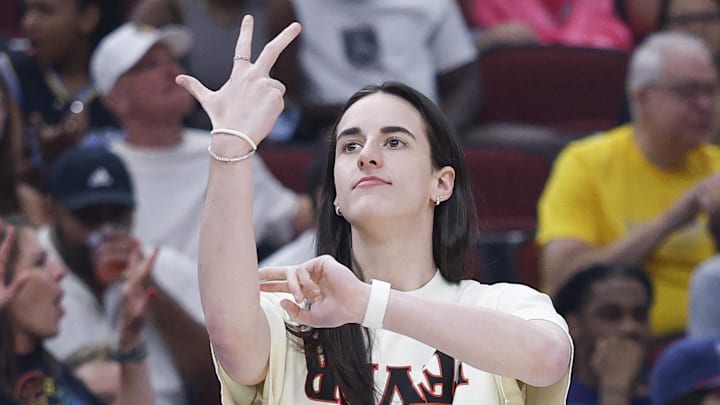 Jul 27, 2025; Chicago, Illinois, USA; Injured Indiana Fever guard Caitlin Clark (22) reacts during the first half of a basketball game against the Chicago Sky at United Center. Mandatory Credit: Kamil Krzaczynski-Imagn Images