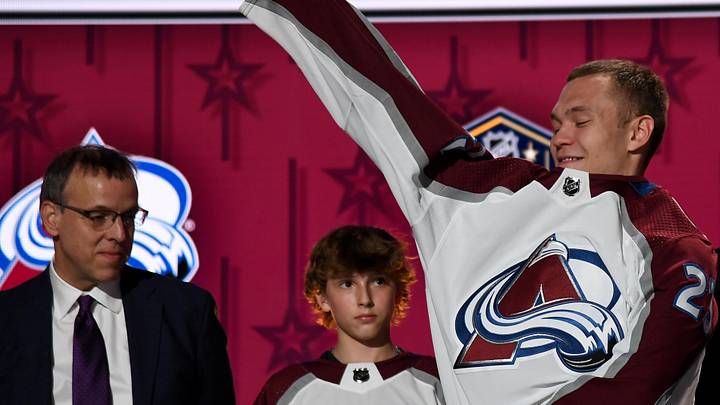 Jun 28, 2023; Nashville, Tennessee, USA; Colorado Avalanche draft pick Mikhail Gulyayev puts on his sweater after being selected with the thirty first pick in round one of the 2023 NHL Draft at Bridgestone Arena. Mandatory Credit: Christopher Hanewinckel-Imagn Images Jun 28, 2023; Nashville, Tennessee, USA; Colorado Avalanche draft pick Mikhail Gulyayev puts on his sweater after being selected with the thirty first pick in round one of the 2023 NHL Draft at Bridgestone Arena. Mandatory Credit: Christopher Hanewinckel-Imagn Images