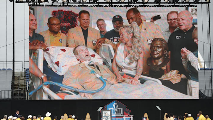 A video is played  at Canton of Steve McMichael during his induction into the Pro Football Hall of Fame with teammates around him at home.