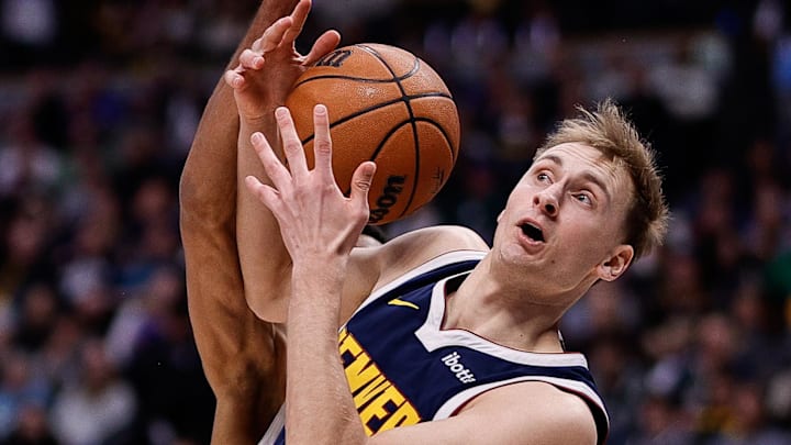 Feb 12, 2025; Denver, Colorado, USA; Denver Nuggets forward Hunter Tyson (5) battles for a rebound with Portland Trail Blazers guard Rayan Rupert (21) in the third quarter at Ball Arena. Mandatory Credit: Isaiah J. Downing-Imagn Images