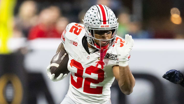 Jan 20, 2025; Atlanta, GA, USA; Ohio State Buckeyes running back TreVeyon Henderson (32) against the Notre Dame Fighting Irish during the CFP National Championship college football game at Mercedes-Benz Stadium. Mandatory Credit: Mark J. Rebilas-Imagn Images