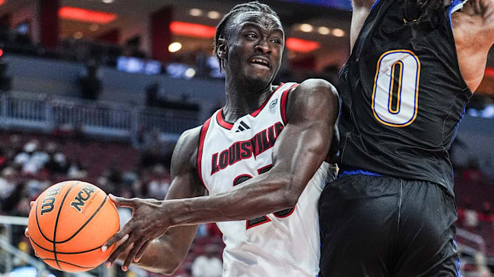 Louisville Cardinals forward Aboubacar Traore (25) looks to pass around Spalding University's Caden Bradford (0) at the KFC Yum! Center in Louisville, Kentucky Monday, Oct. 28, 2024. Louisville Cardinals forward Aboubacar Traore (25) looks to pass around Spalding University's Caden Bradford (0) at the KFC Yum! Center in Louisville, Kentucky Monday, Oct. 28, 2024.