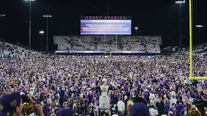 Husky fans rush the field to celebrate beating Michigan. 