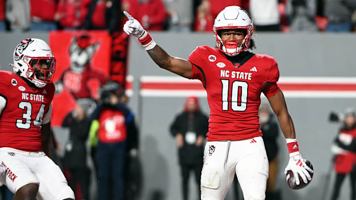 Nov 25, 2023; Raleigh, North Carolina, USA; North Carolina State Wolfpack receiver KC Concepcion (10) reacts after scoring a touchdown against the North Carolina Tar Heels during the first half at Carter-Finley Stadium. Mandatory Credit: Rob Kinnan-Imagn Images