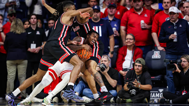 Houston Cougars forward Joseph Tugler (11) and guard Milos Uzan (7) double team Arizona Wildcats guard Jaden Bradley (0) during the first half at McKale Center. Houston Cougars forward Joseph Tugler (11) and guard Milos Uzan (7) double team Arizona Wildcats guard Jaden Bradley (0) during the first half at McKale Center.