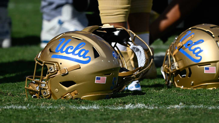 Nov 30, 2024; Pasadena, California, USA; UCLA Bruins helmets during pregame warmups before playing the Fresno State Bulldogs at Rose Bowl. Mandatory Credit: Robert Hanashiro-Imagn Images