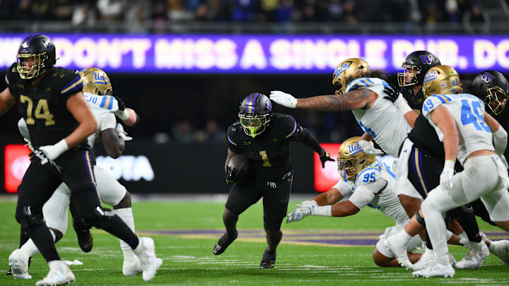 Nov 15, 2024; Seattle, Washington, USA; Washington Huskies running back Jonah Coleman (1) carries the ball against the UCLA Bruins during the second half at Alaska Airlines Field at Husky Stadium. Mandatory Credit: Steven Bisig-Imagn Images